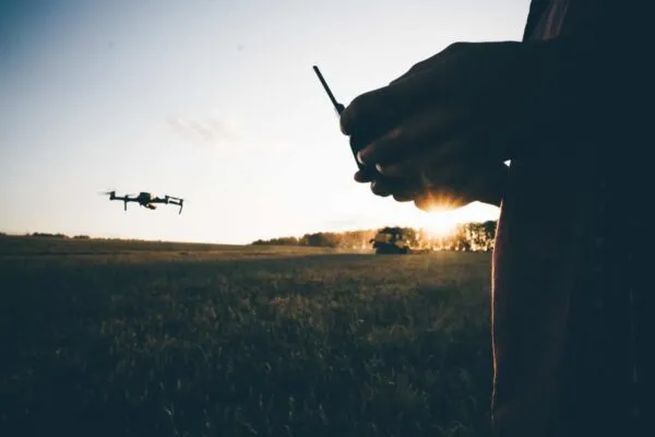 Drone for industrial works flying above combine harvester. Farmer navigating drone above farmland with combine at the background. High technology innovations in agriculture. | Medaro Mining Completes an Airborne Geophysical Survey at Yurchison Uranium Property in Athabasca Basin, Saskatchewan