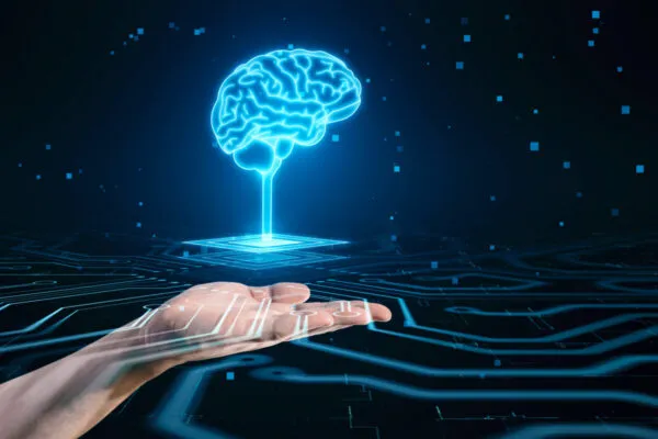 Artificial intelligence, science, innovations and network technologies concept with digital blue glowing human brain on platform above man hand on abstract dark technological background with circuit | IMAGINiT Technologies Exhibits with Eagle Point Software at the 2023 AIA Conference